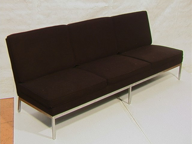 KNOLL Armless Sofa Couch. Stainless Base. Origina: KNOLL Armless Sofa Couch. Stainless Base. Original Black Upholstery. Unmarked. En Suite with Previous Lot.-- Dimensions: H: 32 inches: D: 30 inches: L: 86 inches --- Condition (General): Very Good Con