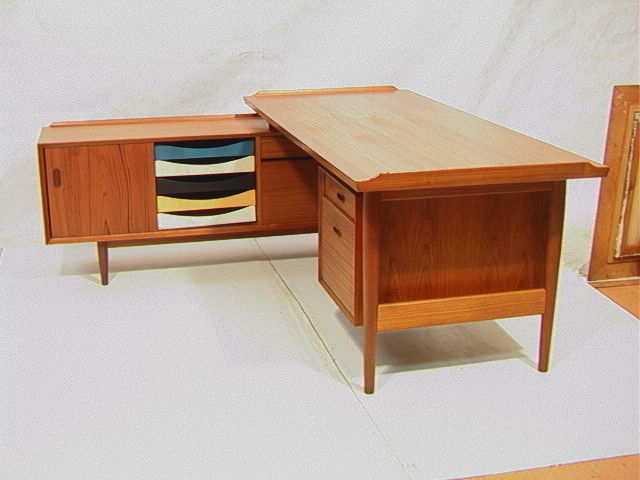 ARNE VODDER style "L" shaped Desk. Danish Teak. T: ARNE VODDER style "L" shaped Desk. Danish Teak. Tapered Peg Legs. Credenza side has colored front drawers. Rolled edge. Danish Control Tag.-- Dimensions: H: 28.5 inches: D: 72 inches: L: 71 inches ---