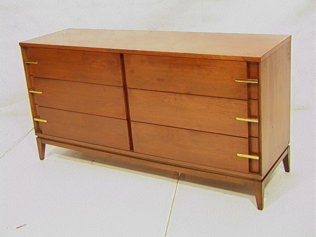 American Modern Walnut Credenza Dresser. BASIC-WI: American Modern Walnut Credenza Dresser. BASIC-WITZ. Stylish 6 drawer form with recessed edges and brass pulls. Marked. -- Dimensions: H: 30.5 inches: D: 18 inches: L: 60 inches --- Condition (General