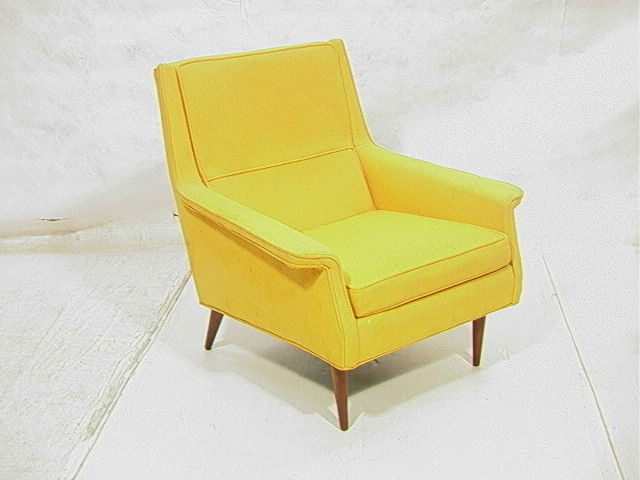 THAYER COGGIN Upholstered Lounge Chair. Wide upho: THAYER COGGIN Upholstered Lounge Chair. Wide upholstered paddle arms. Tapered Peg Legs. Marked. -- Dimensions: H: 32 inches: W: 32 inches: D: 34 inches --- Condition (General): Spots and stains to yel