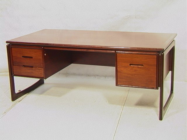 DYRLUND Danish Rosewood Executive Desk. Open Leg: DYRLUND Danish Rosewood Executive Desk. Open Leg Sides. Marked.-- Dimensions: H: 28.5 inches: D: 35 inches: L: 71 inches --- Condition (General): Wear to front edge. Some surface scratches. Please con