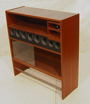 Eric Buck Danish Modern Teak Bar. Back outfitted: Eric Buck Danish Modern Teak Bar. Back outfitted with shelves, two slide out bowls, Sliding glass door and cubby holes.-- Dimensions: H: 45.25 inches: W: 43.5 inches: D: 16 inches --- Condition (Gener