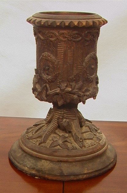 Black Forest Carved Walnut Planter Base.: Black Forest Carved Walnut Planter Base. Flat edge to part of the round base. -- Dimensions: H: 13 inches: W: 9 inches --- Please contact us with specific questions about condition, not visible in the