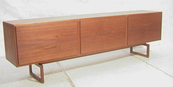 Danish Modern Teak Sideboard Credenza. Long form: Danish Modern Teak Sideboard Credenza. Long form with Drawers and doors. Raised on legs.-- Dimensions: H: 28.5 inches: W: 94.5 inches: D: 18 inches --- Condition (General): Chips to back leg. Minor sc