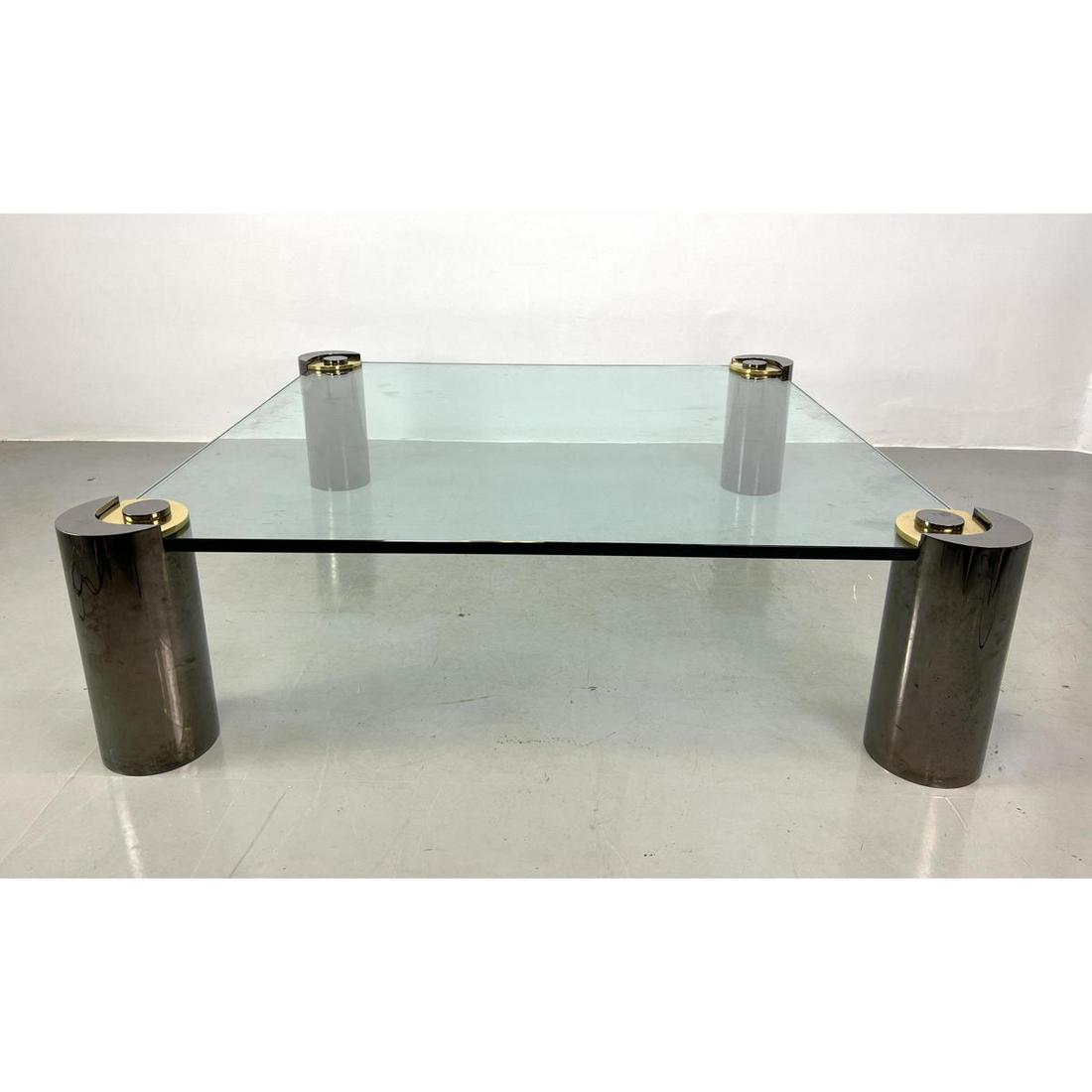 KARL SPRINGER Signed Metal Glass Cocktail Table. Four Thick Sturdy Gun Metal Tone Column legs suppor: KARL SPRINGER Signed Metal Glass Cocktail Table. Four Thick Sturdy Gun Metal Tone Column legs support 60" Oversized Glass Top. Glass measures 60 x 60. Marked and dated 1987. Dimensions: H: 18 inches: