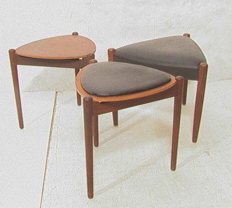 3pcs Danish Modern Triangle Stool Tables. Two ha: 3pcs Danish Modern Triangle Stool Tables. Two have reversible tops for wood or Padded. -- Dimensions: H: 16 inches: W: 17 inches --- Condition (General): Few veneer chips to edge of one table. Please 