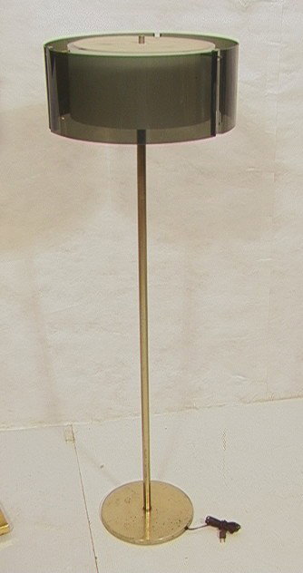 Modernist Laurel Floor Lamp with Smokey Lucite Ac: Modernist Laurel Floor Lamp with Smokey Lucite Acrylic Shade. Interior white shade. -- Dimensions: H: 54.75 inches: W: 17.25 inches --- Condition (General): Metal has wear to finish. Please contact us
