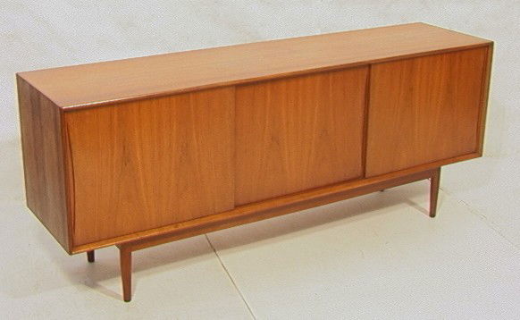 Swedish Modern Teak Sideboard Credenza Cabinet.: Swedish Modern Teak Sideboard Credenza Cabinet. Three sliding doors. Recessed wood pulls. Tapered Legs. Fitted Interior.-- Dimensions: H: 30.5 inches: W: 76.75 inches: D: 19 inches --- Condition (Gene