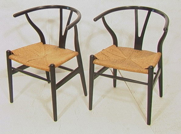 Pair Hans Wegner Wishbone Chairs. Carl Hansen an: Pair Hans Wegner Wishbone Chairs. Carl Hansen and Sons. Ebonized frames. Labeled.-- Dimensions: H: 28.5 inches: W: 19.5 inches: D: 20.5 inches --- Condition (General): Cut to woven seat. Losses to wov