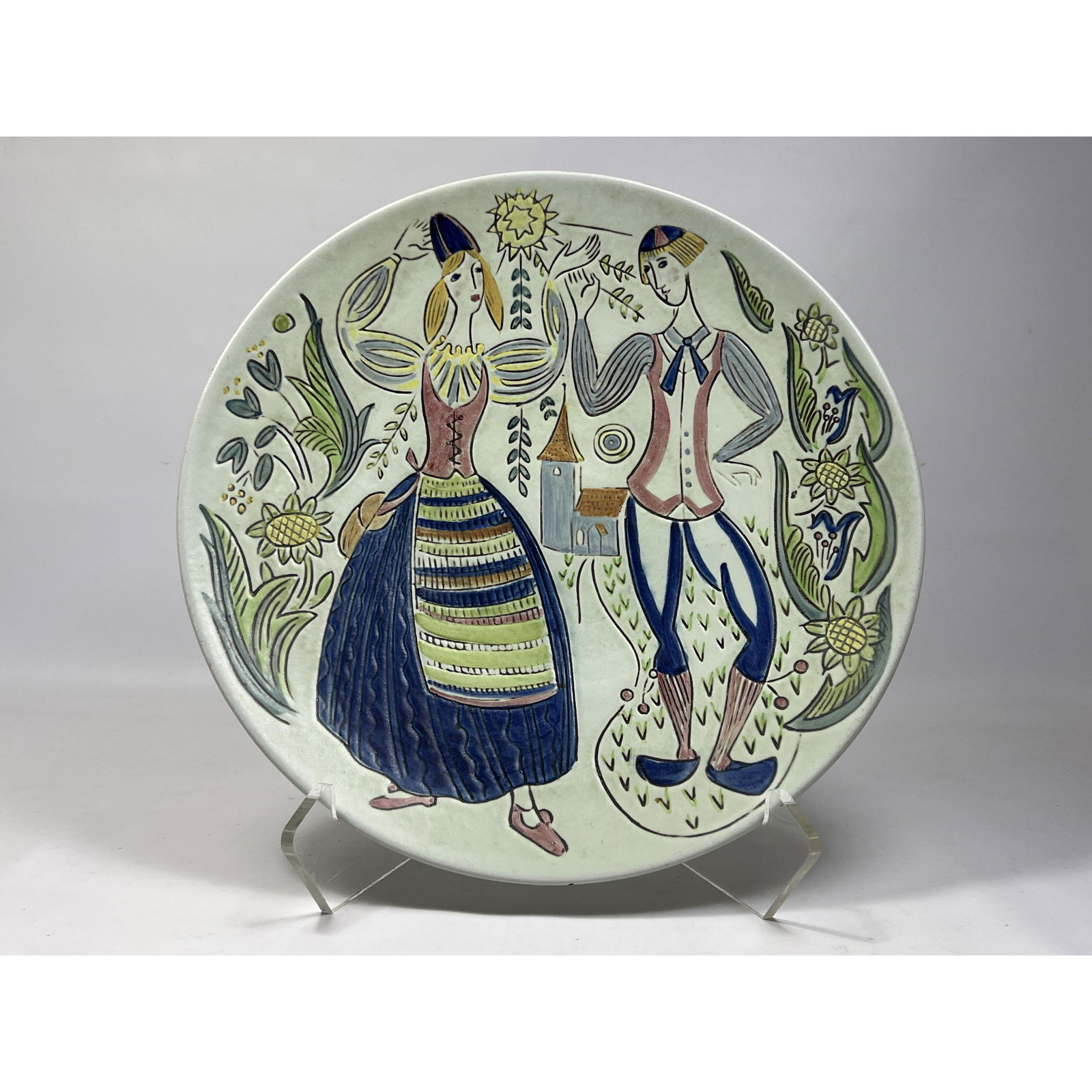 RORSTRAND Sweden Hand Painted Pottery Charger. Colorful incised design of young couple with floral m: RORSTRAND Sweden Hand Painted Pottery Charger. Colorful incised design of young couple with floral motif. Marked. Dimensions: H: 2 inches: W: 14.5 inches: D: 14.5 inches --- US Shipping charge: $50 Pl