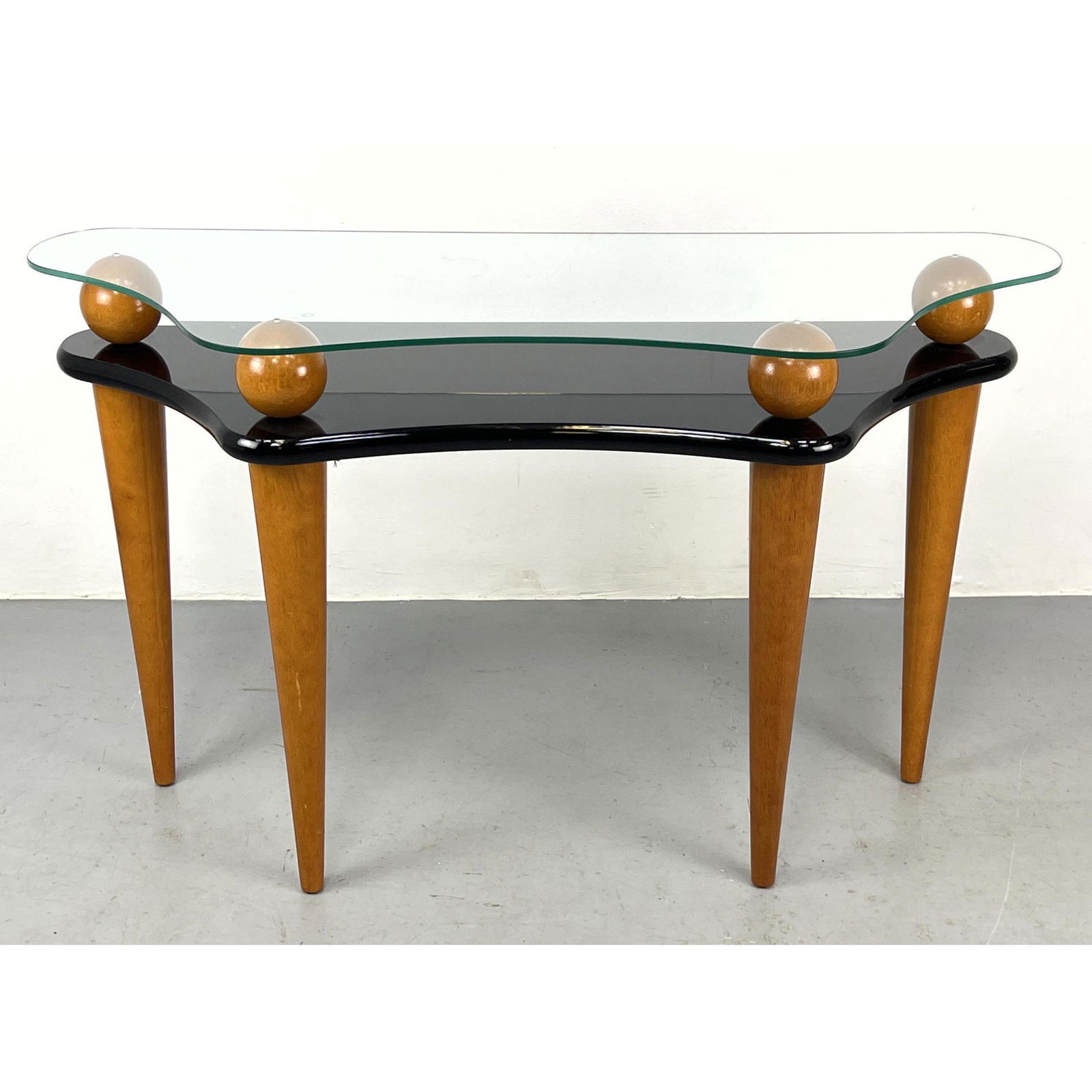 Memphis style Console Hall Table. Shaped glass top rests on natural wood sphere elements. Lower ebon (1 of 10)