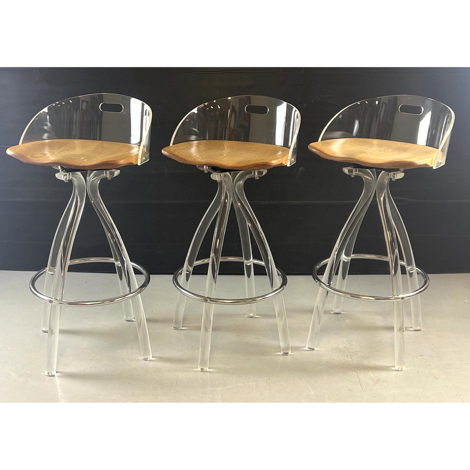 Set 3 Modernist Lucite Swivel Bar Stools. Lucite stem legs with chrome foot rests. Wood Seats. (1 of 8)