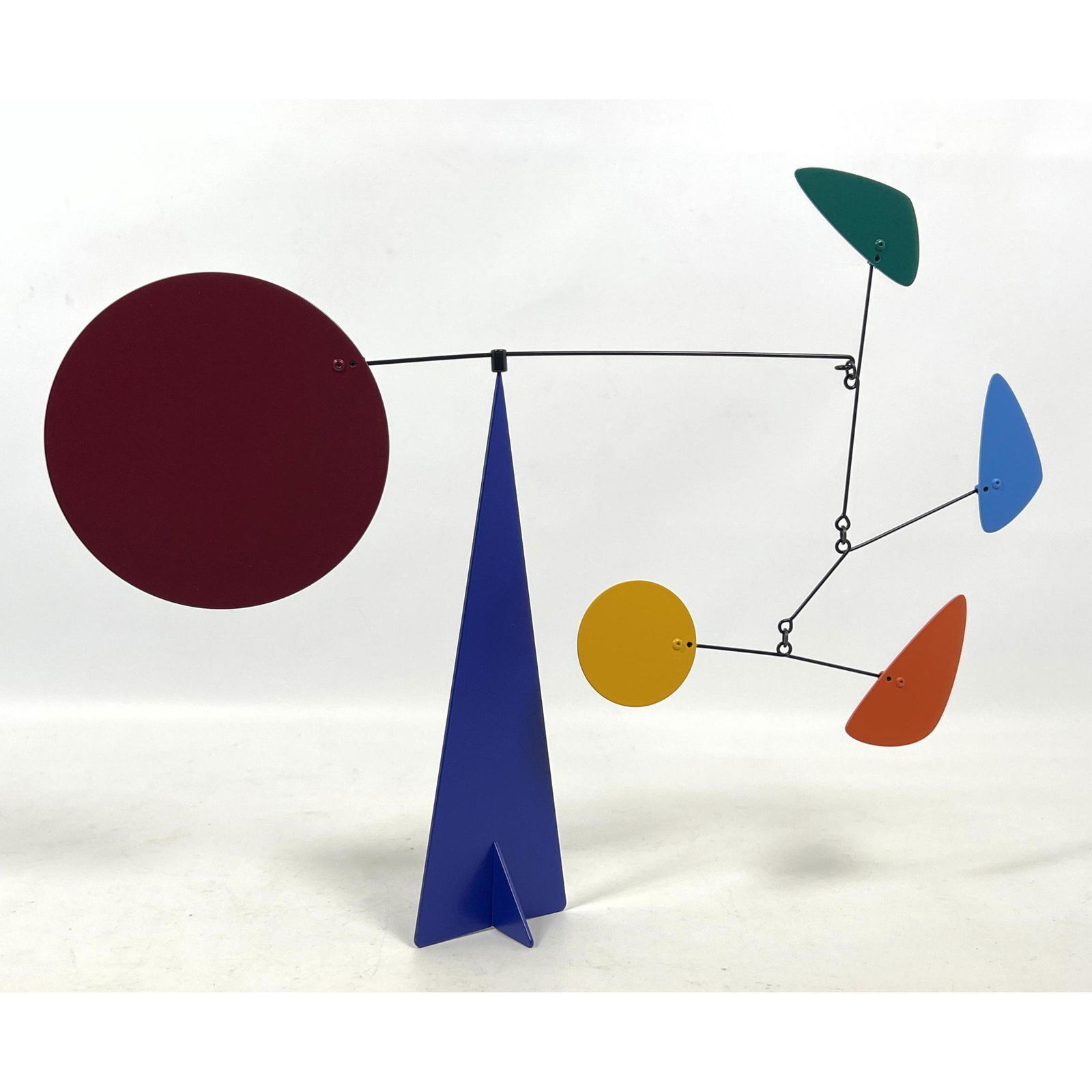Colorful Kinetic Wind Sculpture Stabile. Indoor Metal sculpture with suspended paddles above blue me (1 of 6)