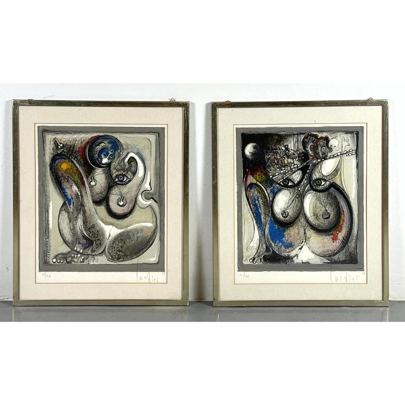 2pcs Signed illegibly dated 77 and numbered Lithograph Prints. 36/98 and 45/98: 2pcs Signed illegibly dated 77 and numbered Lithograph Prints. 36/98 and 45/98 Dimensions: H: 17 inches: W: 14 inches: Frame Height: 22 inches: Frame Width: 19 inches --- US Shipping charge: In house