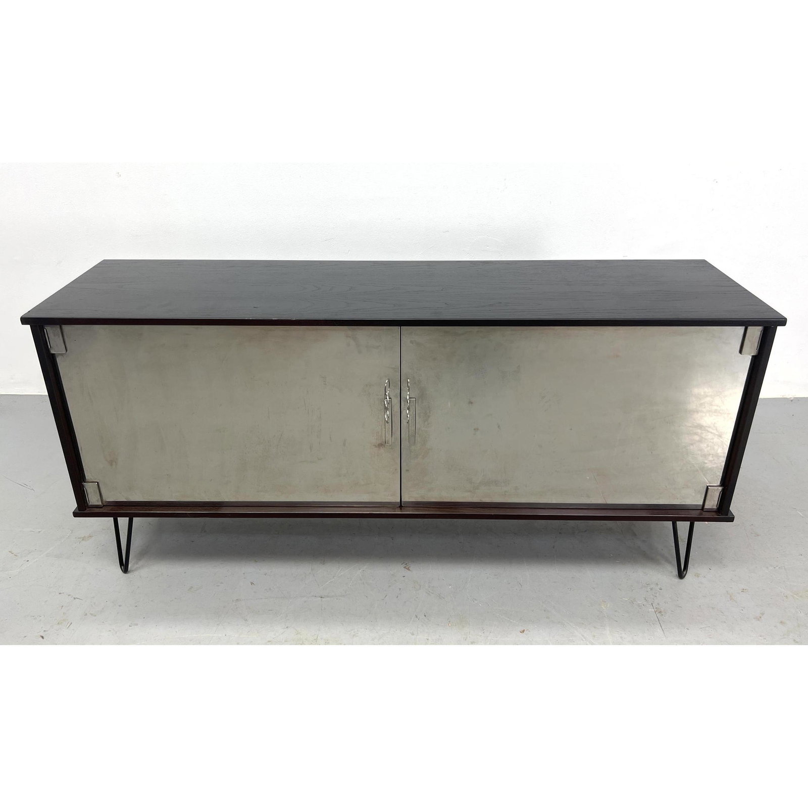 Modernist Steel Door Cabinet on Hairpin Iron Legs. Doors are too heavy for the cabinet. (Wants to fa: Modernist Steel Door Cabinet on Hairpin Iron Legs. Doors are too heavy for the cabinet. (Wants to fall forward when both doors open) Dimensions: H: 25.75 inches: W: 54.5 inches: D: 14.5 inches ---