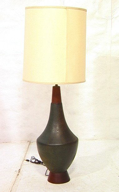 Large Pottery Ceramic Lamp. RAYMOR Attribution. W: Large Pottery Ceramic Lamp. RAYMOR Attribution. Walnut Base and Neck. Thick Dark Glazed Pottery. Unmarked.-- Dimensions: H: 45 inches: W: 11.5 inches ---