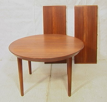Danish Modern Teak Round Dining Table. Two 19" Le: Danish Modern Teak Round Dining Table. Two 19" Leaves. Beveled skirt. Tapered legs. Marked Made in Denmark.-- Dimensions: H: 28.5 inches: W: 49 inches: D: 49 inches ---