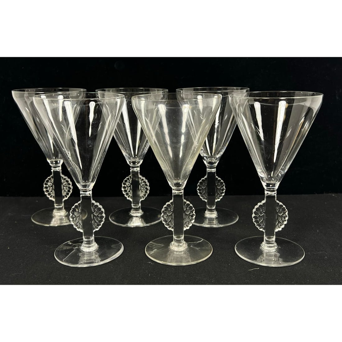 Set 6 Rene Lalique Mulhouse Stem Wine Glasses. Semi circular foliage design on two sides of stem. Li: Set 6 Rene Lalique Mulhouse Stem Wine Glasses. Semi circular foliage design on two sides of stem. Likely model 5050. Signed r Lalique Dimensions: H: 5.5 inches: W: 3 inches: D: 3 inches --- US Packing