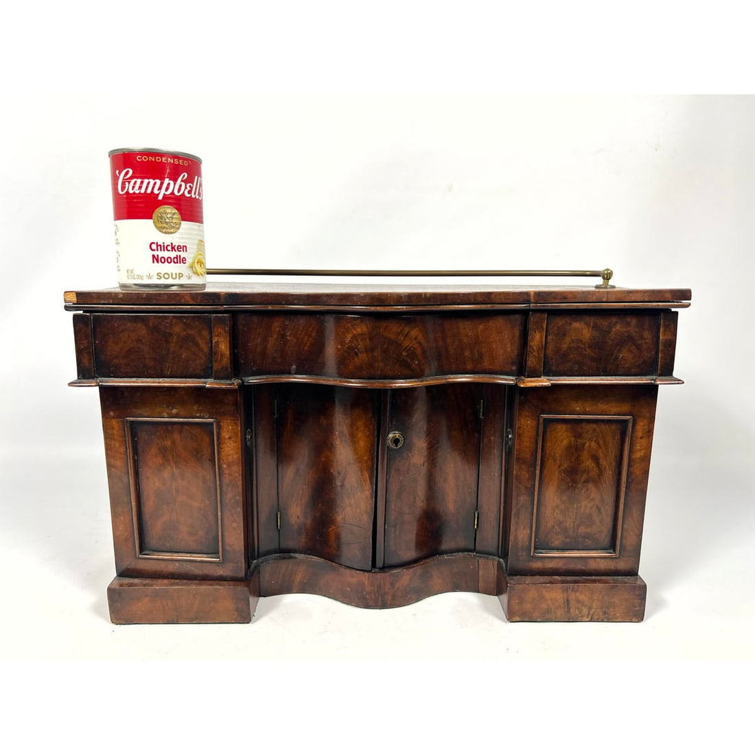 Antique 19th C English Salesman Sample Miniature Serpentine Front Sideboard Buffet. Finely crafted w: Antique 19th C English Salesman Sample Miniature Serpentine Front Sideboard Buffet. Finely crafted with locking doors, a wine bottle caddy inset, dovetails and tapered panels under drawers. Brass rail