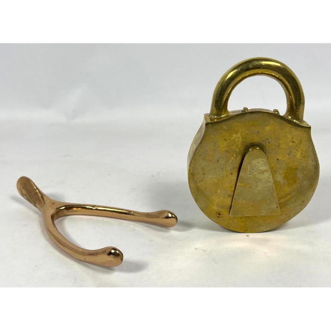 In the style of Carl Aubock Brass Table Top Items. Modernist Wishbone Paperweight. Brass lock lidded (1 of 13)