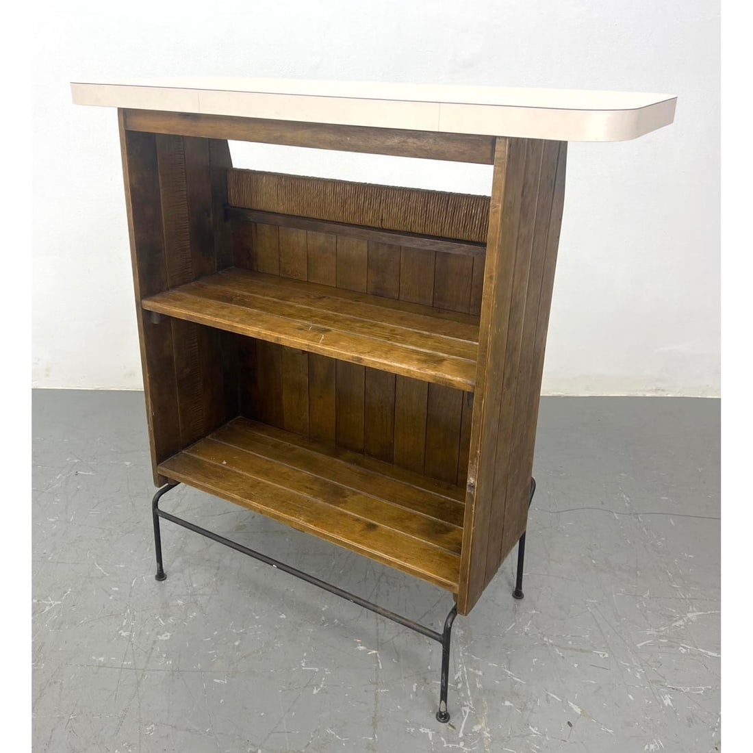 ARTHUR UMANOFF Modernist Wood Slat Bar. Black Hairpin Iron Base. Wrapped Rattan Trim. White Laminate: ARTHUR UMANOFF Modernist Wood Slat Bar. Black Hairpin Iron Base. Wrapped Rattan Trim. White Laminate Top. H: 42.5 inches: W: 42.5 inches: D: 17 inches ---