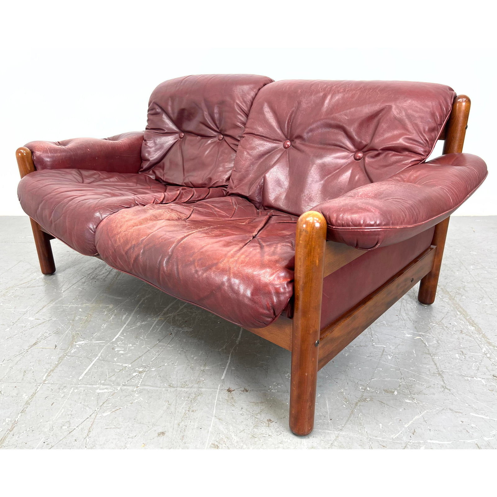 Swedish Leather Modernist Love Seat #2. Teak Frame with slouchy Tufted red leather cushions. Marked.: Swedish Leather Modernist Love Seat #2. Teak Frame with slouchy Tufted red leather cushions. Marked. Dimensions: H: 29.5 inches: W: 60 inches: D: 32 inches - Seat Height: 16.5 inches ---
