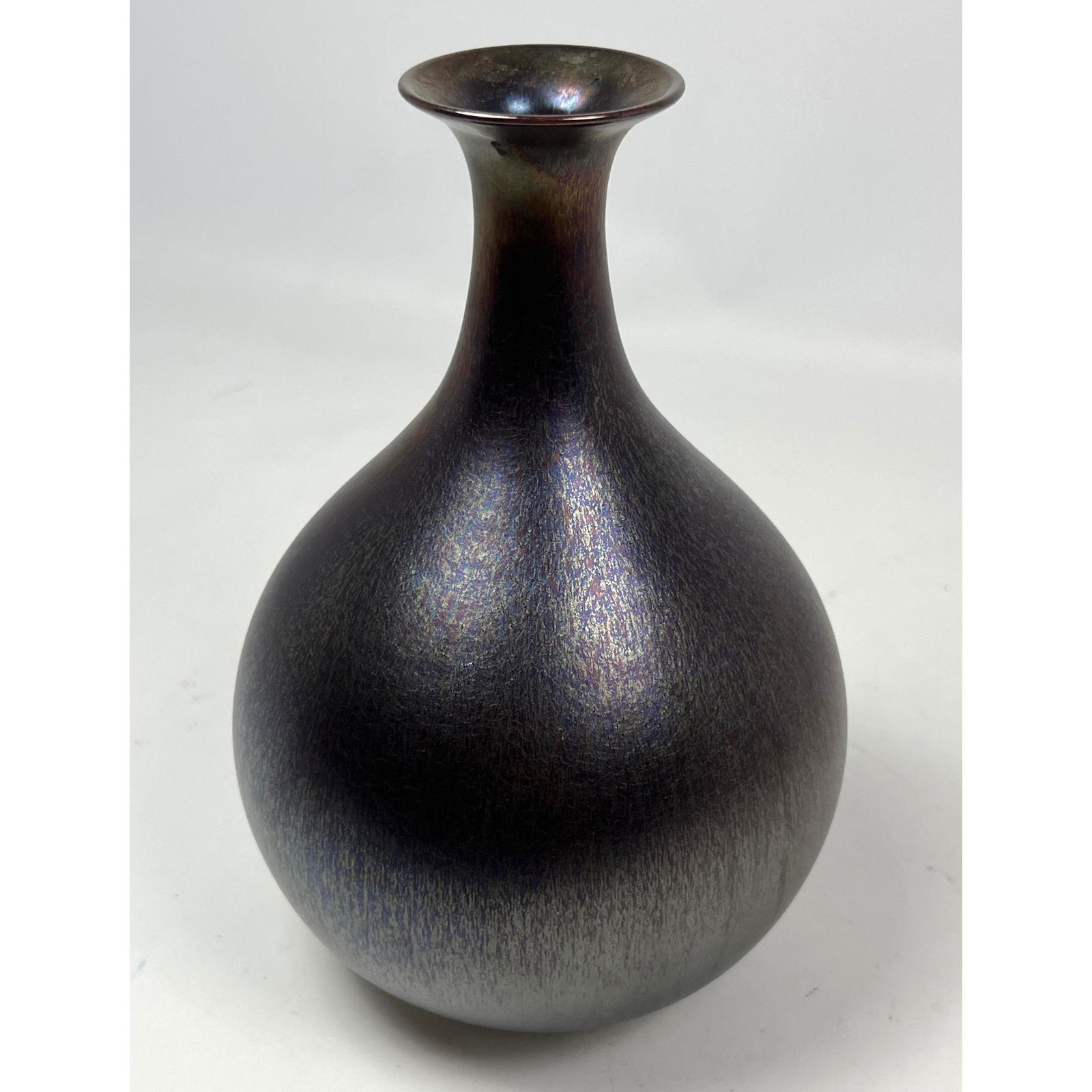HIDEAKI MIYAMURA Iridescent Glazed Porcelain Vase. Yohen Tenmoku glaze. Bulbous form with Wide Lip.: HIDEAKI MIYAMURA Iridescent Glazed Porcelain Vase. Yohen Tenmoku glaze. Bulbous form with Wide Lip. Studio Artisan Pottery. Artist's Signature. Dimensions: H: 9.5 inches: W: 6 inches: D: 6 inches ---