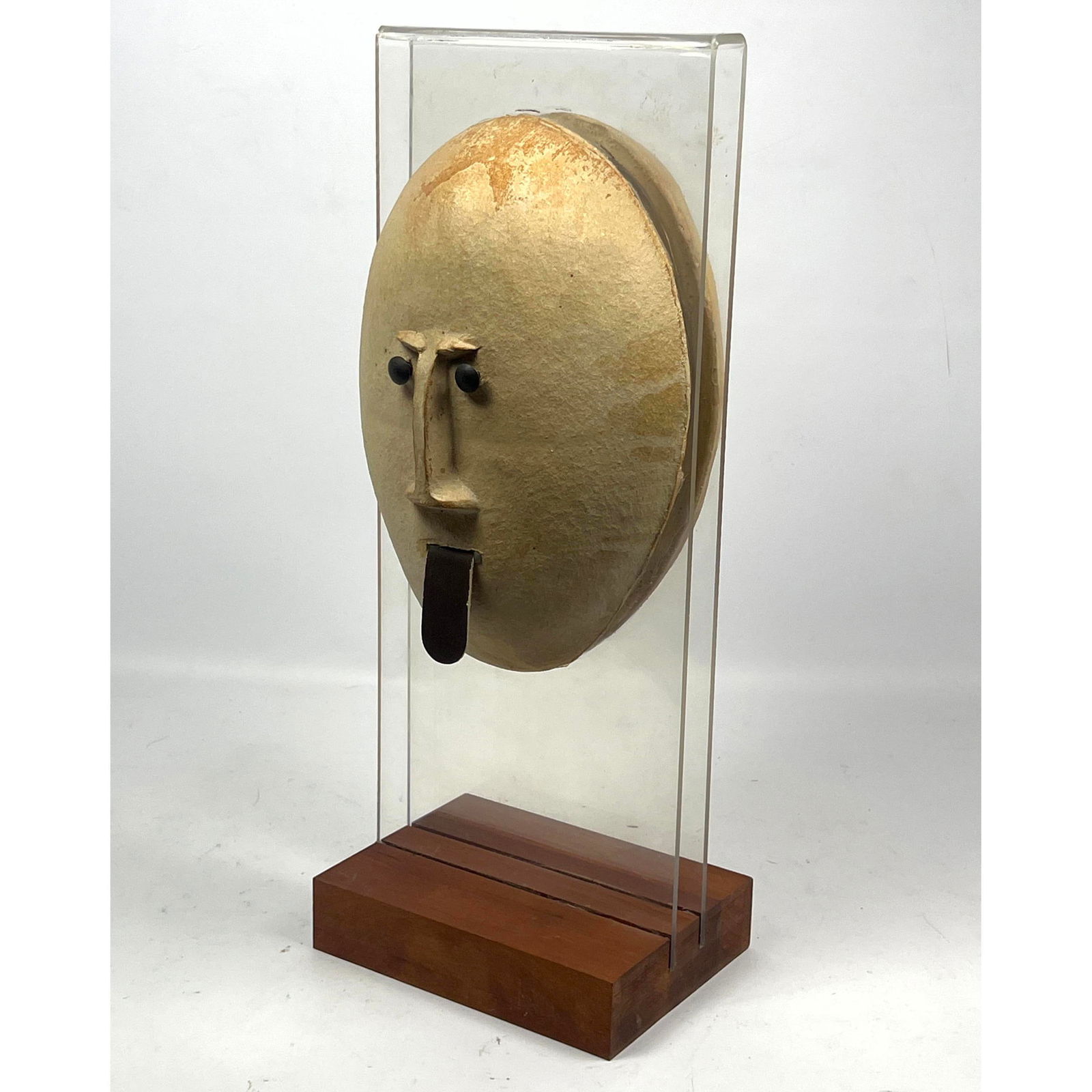 Mid Century DAVID GIL Pottery Round Face Sculpture. BENNINGTON Potters. 2 Part Round Head (Face wi: Mid Century DAVID GIL Pottery Round Face Sculpture. BENNINGTON Potters. 2 Part Round Head (Face with Tongue and Back). Mounted on Lucite with Walnut Base. Marked. Dimensions: H: 19.5 inches: W: 7.5 in