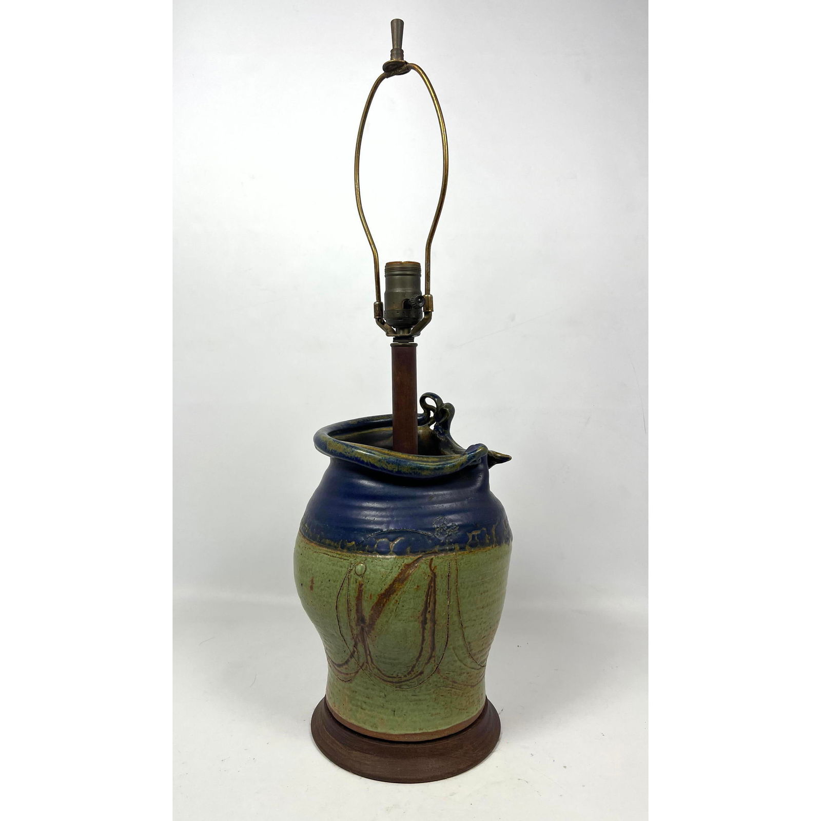 Art Pottery table lamp with slumped edge. Green and blue.: Art Pottery table lamp with slumped edge. Green and blue. Dimensions: H: 25 inches: W: 7.5 inches: D: 7.5 inches --- US Packing and Shipping charge: In house shipping available. Will be calculated onc