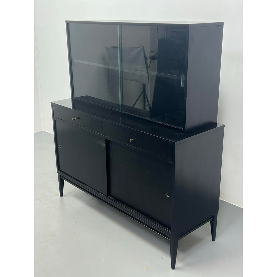 2 Part PAUL McCOBB Ebonized Server,c China Cabinet. PLANNER GROUP. Sliding door base cabinet has dra: 2 Part PAUL McCOBB Ebonized Server,c China Cabinet. PLANNER GROUP. Sliding door base cabinet has drawers. Upper cabinet has sliding glass doors. Label. Dimensions: H: 57.5 inches: W: 52 inches: D: 18.