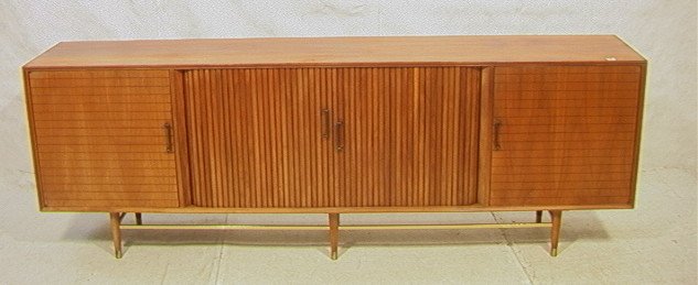 American Modern Walnut Credenza. 8 ft FURNETTE Cr: American Modern Walnut Credenza. 8 ft FURNETTE Credenza Sideboard by Mark Furst & Robert Fellner. Two doors center two tambour doors. Asian style brass handles. Brass capped peg legs. Interior fitted 