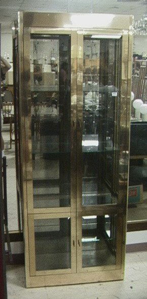 MASTERCRAFT Brass Laminate Display Cabinet. Two T: MASTERCRAFT Brass Laminate Display Cabinet. Two Tall Glass Doors over two small doors. Beveled Glass. Smoked Glass Back. Marked.-- Dimensions: H: 84 inches: W: 32 inches: D: 17 inches ---