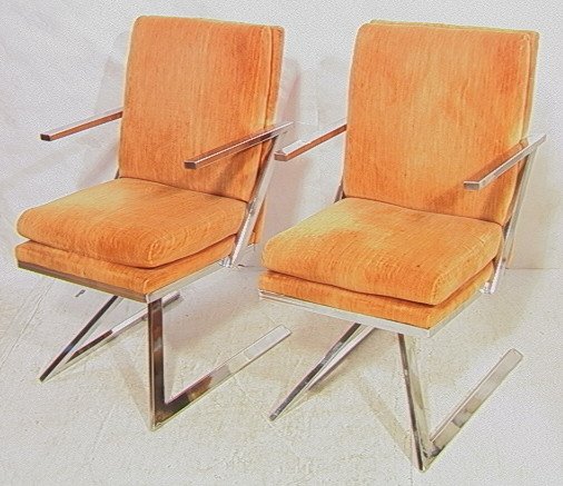 Two MILO BAUGHMAN style Swivel Side Chairs. Z for: Two MILO BAUGHMAN style Swivel Side Chairs. Z form sides. Light orange upholstery. -- Dimensions: H: 34 inches: W: 21 inches: D: 26 inches ---