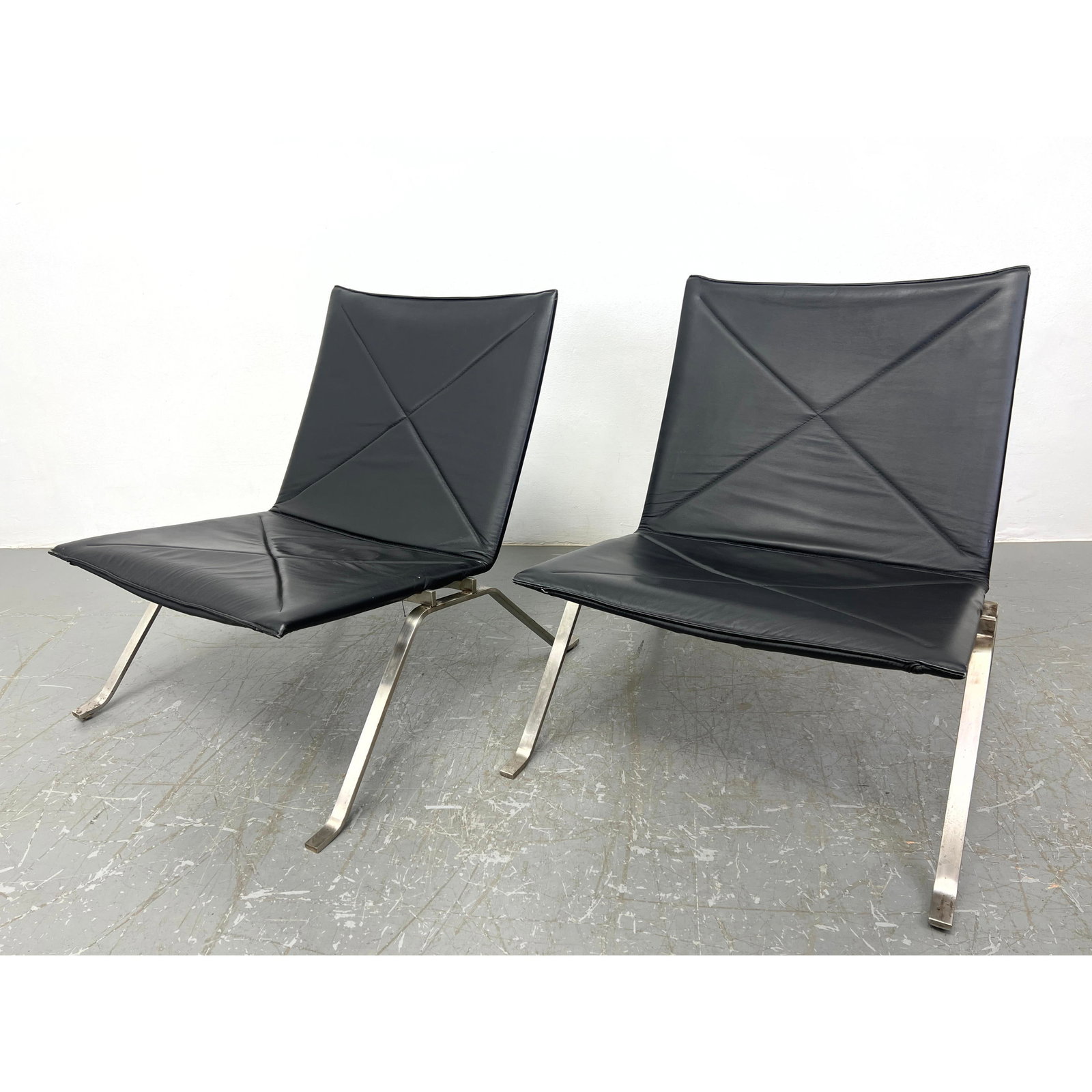 Poul Kjaerholm style Lounge Chairs. Unmarked. Vinyl upholstery.: Poul Kjaerholm style Lounge Chairs. Unmarked. Vinyl upholstery. Dimensions: Height: 28 inches, Width: 25 inches, Depth: 28 inches. ---
