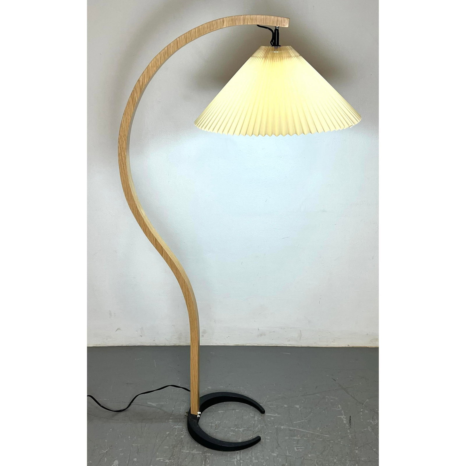CAPRANI. Laminated wood arm. Pleated fabric shade. Black metal base: CAPRANI. Laminated wood arm. Pleated fabric shade. Black metal base Dimensions: Height: 58 inches, Width: 30 inches, Depth: 32 inches. ---