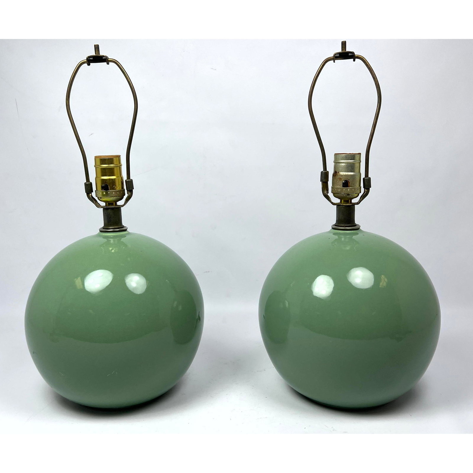 Pair Green pottery spherical orb lamp.: Pair Green pottery spherical orb lamp. Dimensions: Height: 17 inches, Width: 8 inches, Depth: 8 inches. --- US Packing and Shipping charge: In house shipping available. Will be calculated once destina