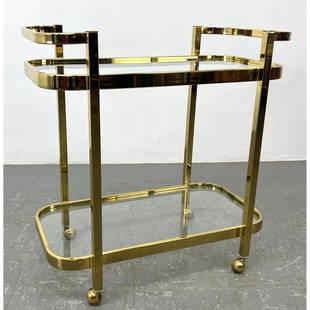 MILO BAUGHMAN for DIA Brass and Glass Serving Bar Cart. Two Glass Tiers. DESIGN INSTITUTE OF AMERICA: MILO BAUGHMAN for DIA Brass and Glass Serving Bar Cart. Two Glass Tiers. DESIGN INSTITUTE OF AMERICA. Rolls on casters Dimensions: Height: 31 inches, Width: 30 inches, Depth: 17 inches. ---