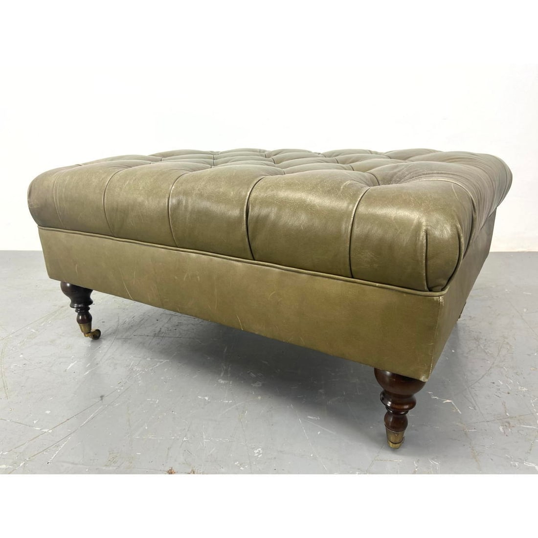Leather Chesterfield Oversized Ottoman Bench. Shaped wood legs on brass casters. (1 of 12)