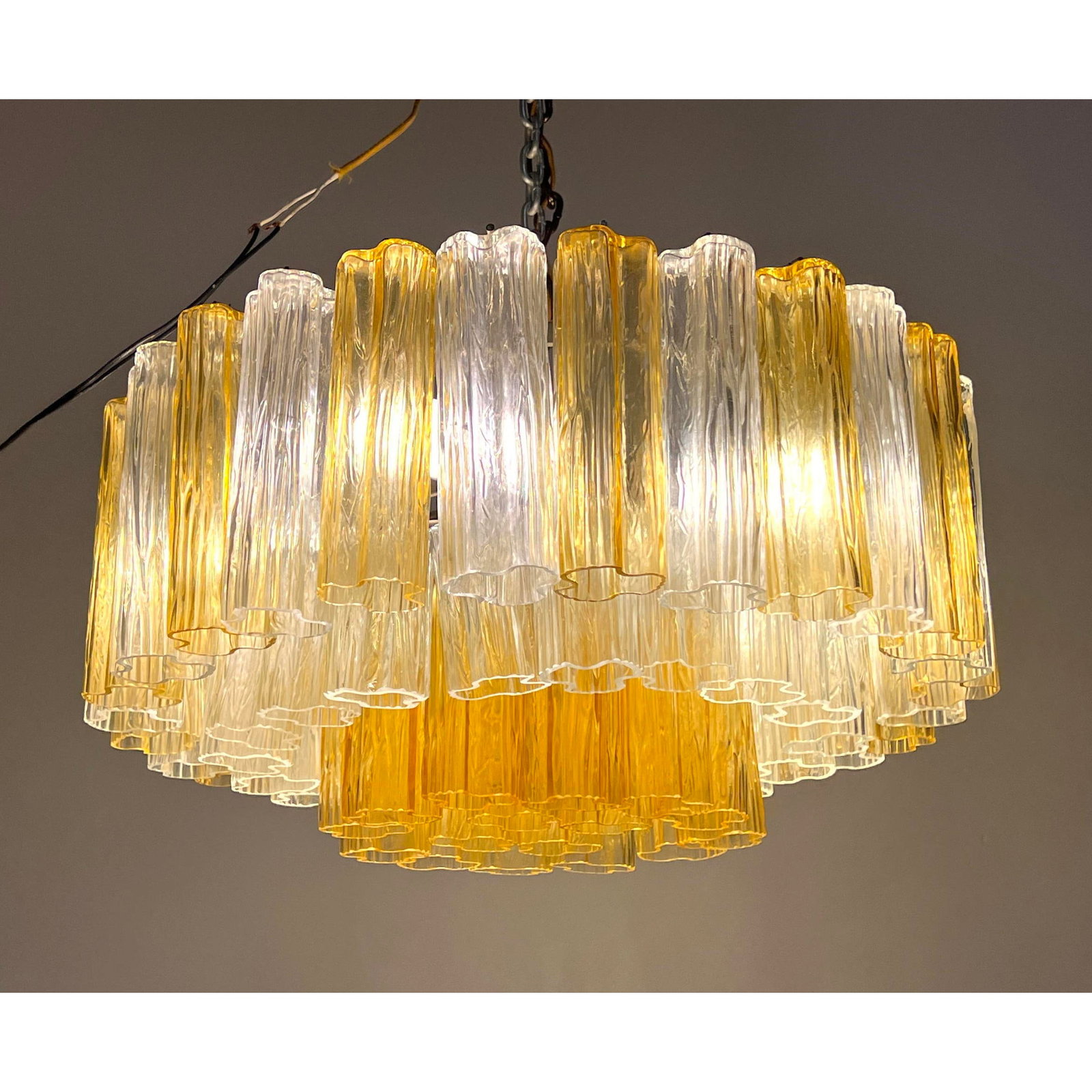 Venini Tonchi 3-Tier Amber and Clear Chandelier. Unsigned. Comes with a few extra prisms: Venini Tonchi 3-Tier Amber and Clear Chandelier. Unsigned. Comes with a few extra prisms Dimensions: Height: 13 inches, Width: 22 inches, Depth: 22 inches. --- We offer curbside delivery to NYC, Manha