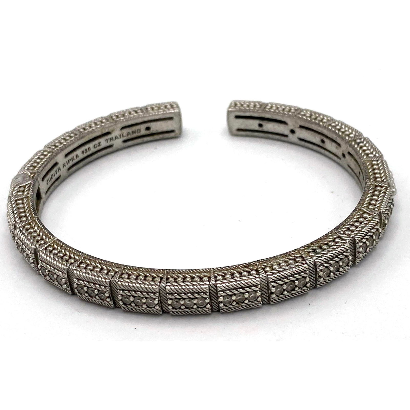 JUDITH RIPKA Sterling Silver CZ Heavy Hinged Bracelet. A row of CZs across top. Marked.: JUDITH RIPKA Sterling Silver CZ Heavy Hinged Bracelet. A row of CZs across top. Marked. --- US Packing and Shipping charge: Jewelry Flat Rate combined Shipping: $10 per item $4 each additional item. $