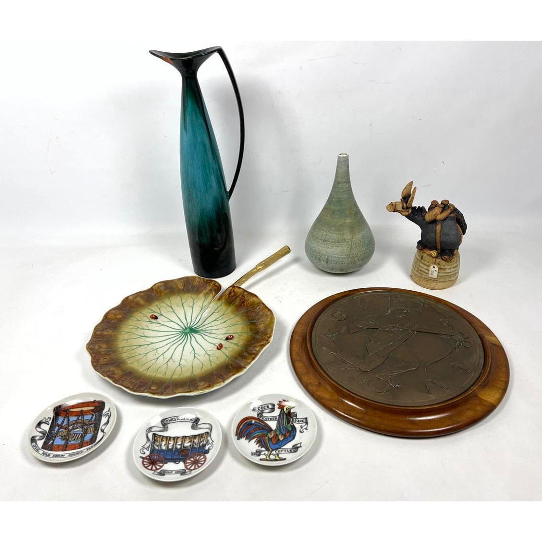 Mid Century Modern Pottery Lot. Todd Warner Figural Bell, Fornasetti style coasters, Italian leaf d: Mid Century Modern Pottery Lot. Todd Warner Figural Bell, Fornasetti style coasters, Italian leaf dish, Art pottery. Dimensions: Height: 12 inches, Width: 12 inches, Depth: 1 inches. --- US Packing an