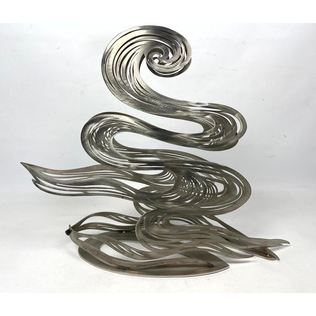 Modernist BABETTE BLOCH 2007 Steel Table Sculpture. "Swan Wave" Stainless Steel form. 14" Tall Sculp: Modernist BABETTE BLOCH 2007 Steel Table Sculpture. "Swan Wave" Stainless Steel form. 14" Tall Sculpture of Undulating form. Signed and dated. Dimensions: Height: 14 inches, Width: 13 inches, Depth: 5