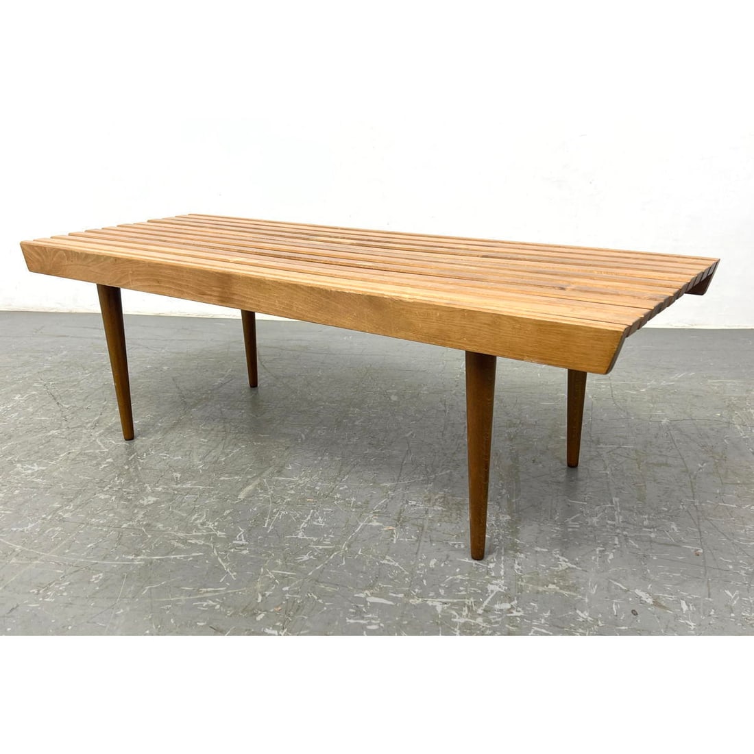 Modernist Slat Bench. Tapered peg legs. Marked Yugoslavia.: Modernist Slat Bench. Tapered peg legs. Marked Yugoslavia. Dimensions: Height: 16 inches, Width: 48 inches, Depth: 18 inches. ---