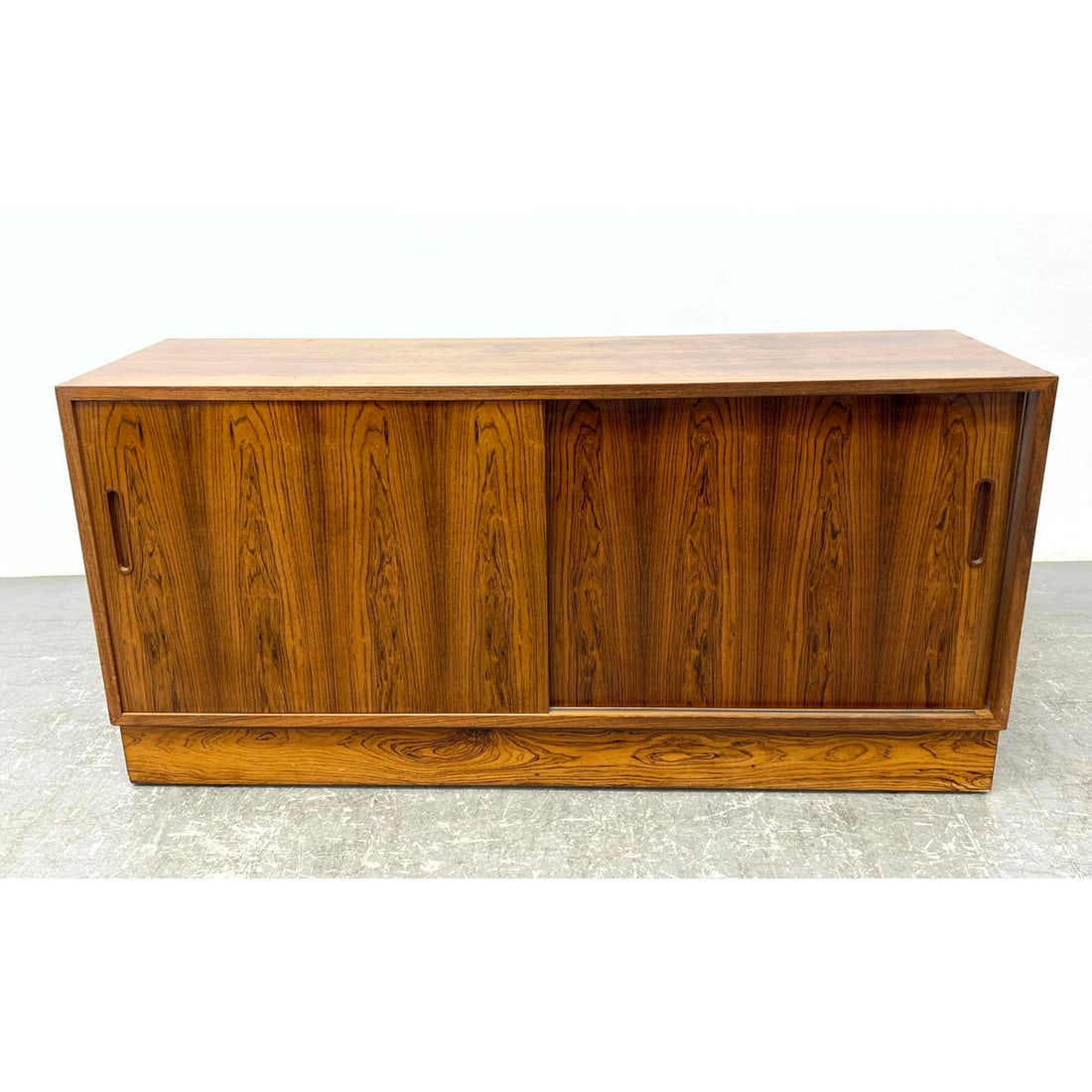 Danish Modern Rosewood Credenza Cabinet. Metal Danish Tag.: Danish Modern Rosewood Credenza Cabinet. Metal Danish Tag. Dimensions: Height: 26.5 inches, Width: 55 inches, Depth: 17 inches. ---