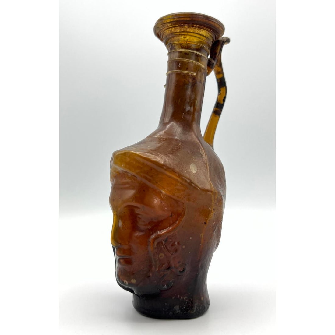 Amber Gladiator face handled jug Ancient Roman glass. PROVENANCE INFO: These items are from the Phil (1 of 10)