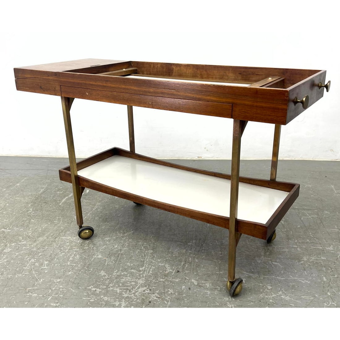 Walnut, brass and laminate bar cart with flipped side compartment: Walnut, brass and laminate bar cart with flipped side compartment Dimensions: Height: 29 inches, Width: 44.5 inches, Depth: 17.5 inches. --- - - We offer curbside delivery to NYC, Manhattan, Close Bro