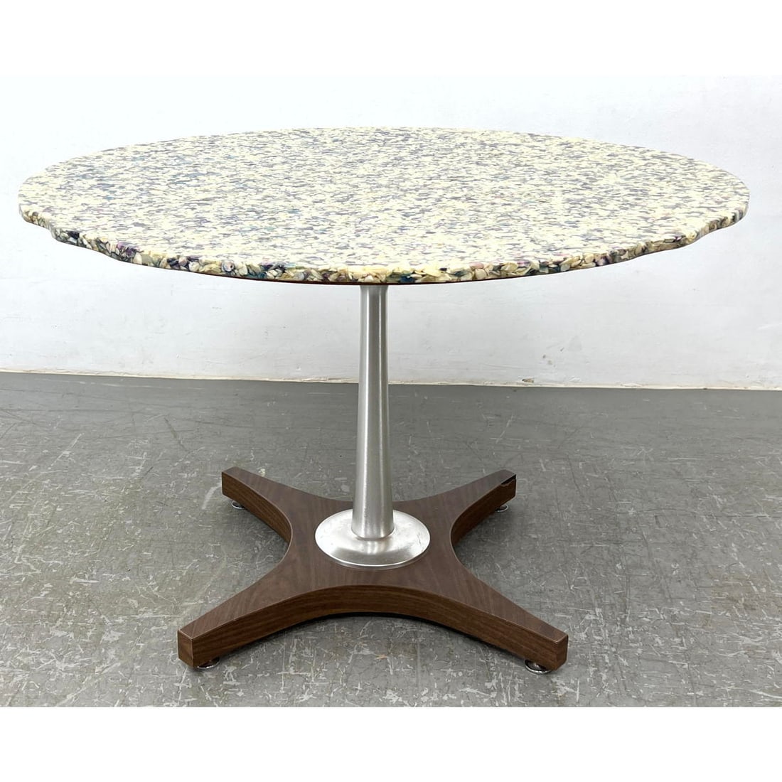 Modernist Dining Table. Aggregate pebble top in resin. Pedestal base has wood feet. Shaped top.: Modernist Dining Table. Aggregate pebble top in resin. Pedestal base has wood feet. Shaped top. Dimensions: Height: 28 inches, Width: 42 inches, Depth: 42 inches. --- - - We offer curbside delivery to