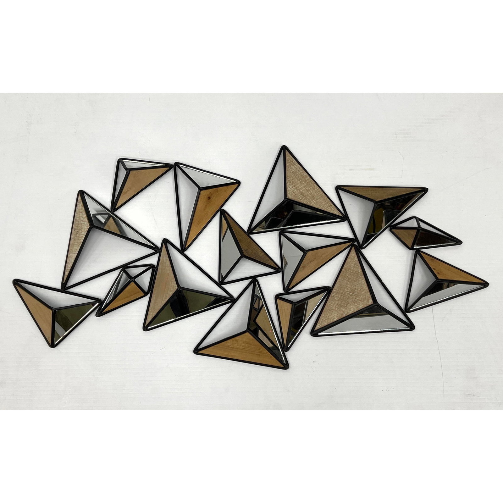 Mixed Media Triangular Pyramid Wall Sculpture. Various size pyramids with mirrored and wood veneer p: Mixed Media Triangular Pyramid Wall Sculpture. Various size pyramids with mirrored and wood veneer panels. Dimensions: Height: 22.5 inches, Width: 44 inches, Depth: 3 inches. --- - - We offer curbside
