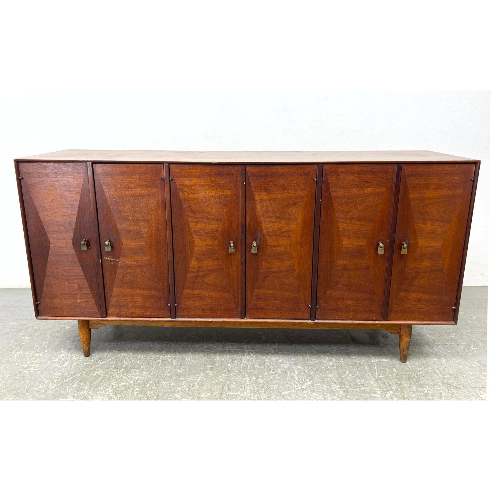 RAMSEUR Modernist Credenza Sideboard. Door Panels with Hourglass Designs.: RAMSEUR Modernist Credenza Sideboard. Door Panels with Hourglass Designs. Dimensions: Height: 33 inches, Width: 66 inches, Depth: 19 inches. --- - - We offer curbside delivery to NYC, Manhattan, Close