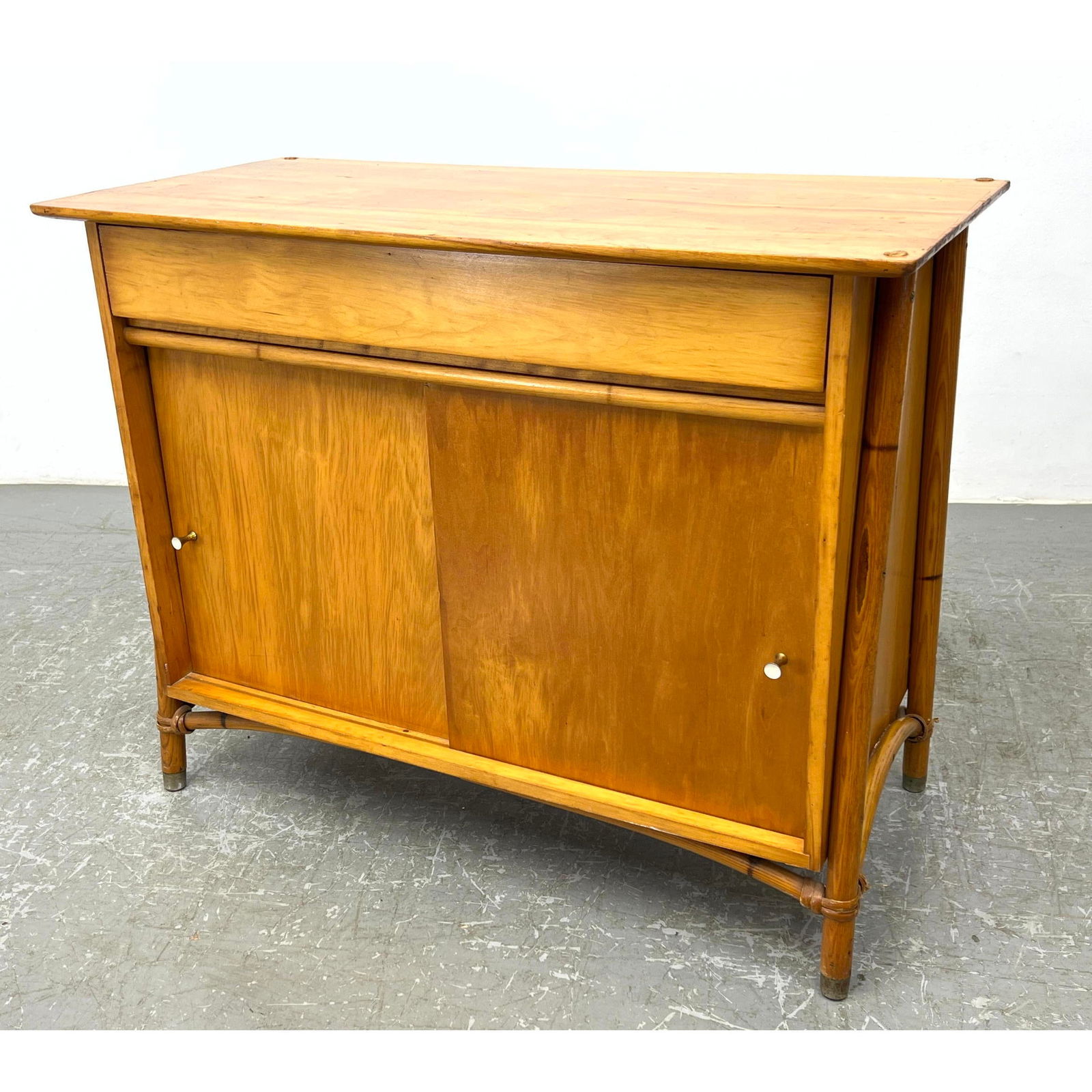 Haywood Wakefield server cabinet. One drawer, two sliding doors. Rattan sides. Stamped (1 of 14)